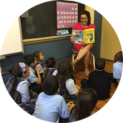 A teacher reading "Alex and the Amazing Lemonade Stand" to her class 